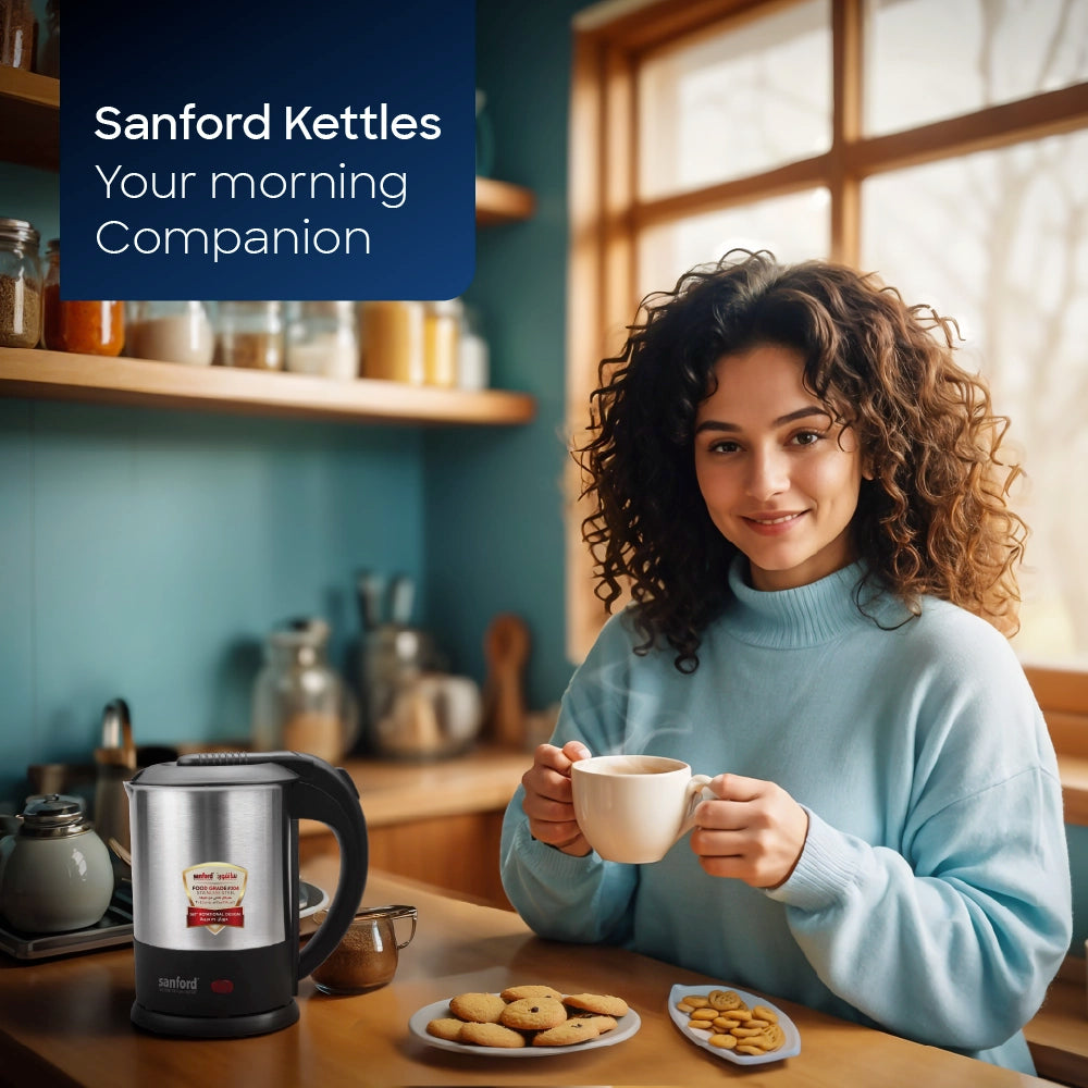 Sanford Electric Kettle – lifestyle image of a woman enjoying a hot drink beside the kettle in a kitchen.